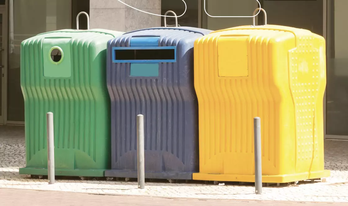 Dustbins in a row in the colors from left to right, green, blue and yellow.